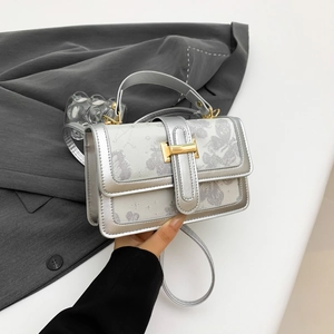 Silver embroidered crossbody bag with metallic finish and gold hardware handle