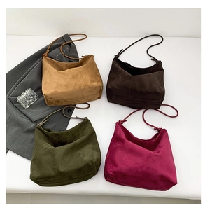 Detail of four matte suede tote bags in camel, chocolate, olive green and deep rose colors