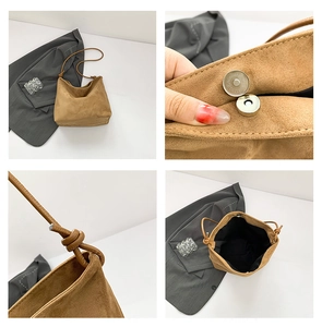 Detail of camel suede tote bag showing magnetic closure and interior storage space