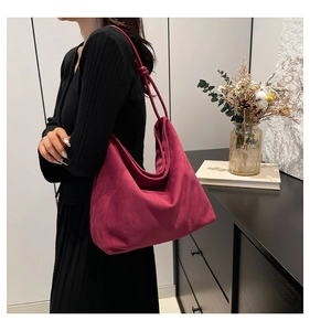 Close-up of fuchsia suede tote bag showing soft texture and spacious minimalist design