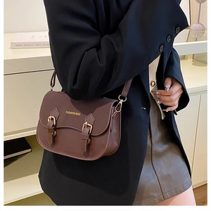 Side view of a dark brown retro crossbody bag with gold hardware and flap closure
