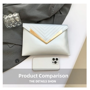 Detail of silver envelope clutch with V-shaped quilting and gold metal V-logo accent