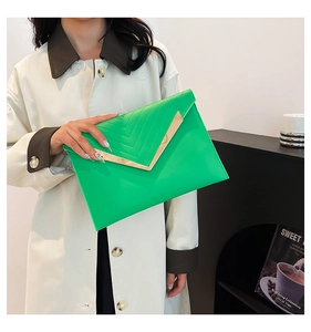 Detail of lime green envelope clutch with V-shaped metal trim and chevron stitching