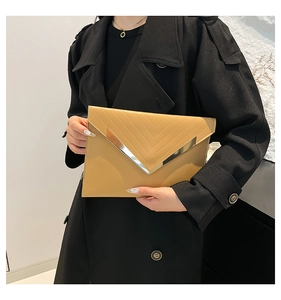 Detail view of khaki envelope clutch with golden V-metal trim and embossed texture