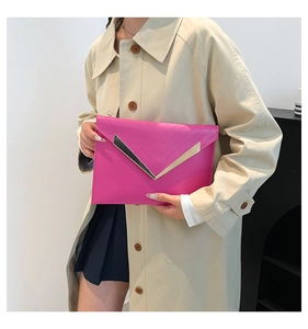 Fashionable magenta quilted envelope clutch bag with V-shaped metal hardware detail