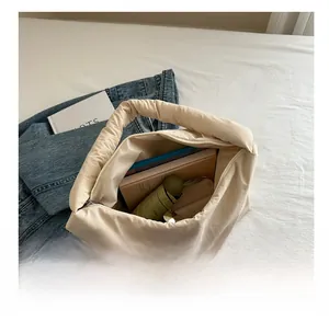 Vista dall'alto di una capiente borsa trapuntata color crema con ampio spazio interno