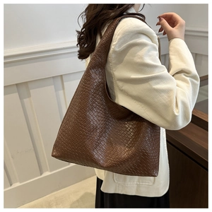 Close-up of deep brown hobo tote bag featuring a premium woven leather checkerboard pattern