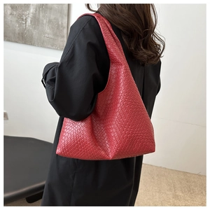 Detail of red woven texture shoulder bag with refined craftsmanship for women