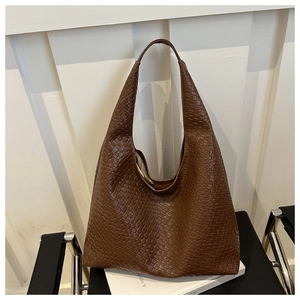 Detail of deep brown woven texture and embossed finish on this large hobo tote bag