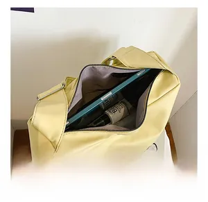 Top view of yellow crossbody bag interior showing spacious storage for a phone and cosmetics