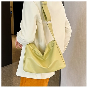 Detail of soft leather tote bag with adjustable wide shoulder strap and silver hardware