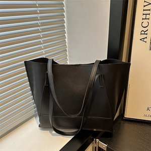 Minimalist large black PU leather tote bag with long straps for chic office commuting