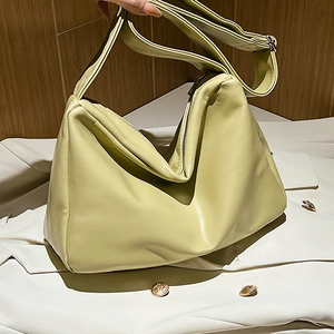 Light green soft leather shoulder bag with minimalist slouchy design and silver zipper
