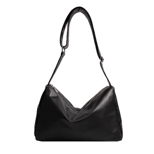 Minimalist black soft leather hobo bag with adjustable strap and silver zipper closure