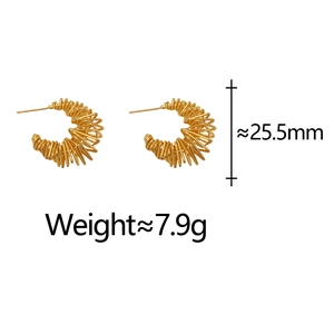 Detail shot of gold spiral hoop earrings measuring 25.5mm with a unique twisted texture