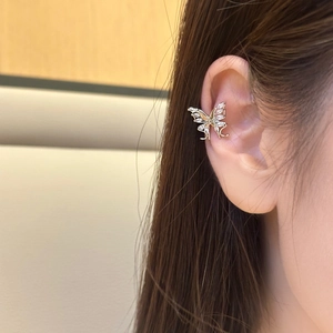 Elegant gold butterfly ear cuff featuring marquise-cut zircon stones on model's ear