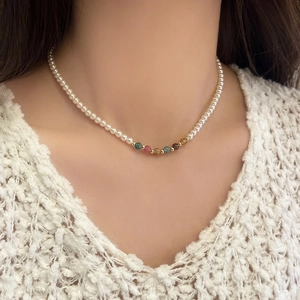 Elegant handmade natural stone and pearl beaded necklace set worn on a cozy sweater