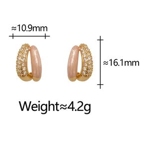 Detail view of double-layer vintage earrings with zircon pavé and nude enamel finish