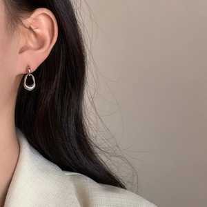 Minimalist silver geometric dangle earrings featuring a double ring and oval pendant
