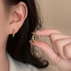 Minimalist gold-plated geometric twist hoop earrings with sparkling zircon inlay