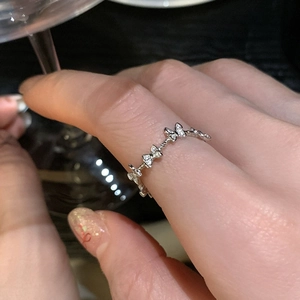 Elegant silver butterfly ring with micro-set zircon stones shown on hand