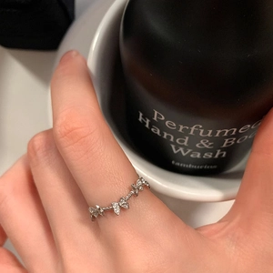 Elegant silver butterfly ring with micro-pave zircons shown on a model's hand