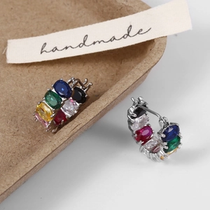Detail of U-shaped earrings with colorful cubic zirconia and silver plating