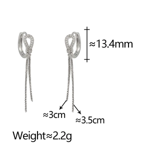 Detail of horseshoe zircon tassel earrings showing precise 13.4mm size and chain length