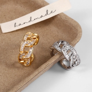 Macro view of gold and silver chain rings with baguette cubic zirconia in a tray