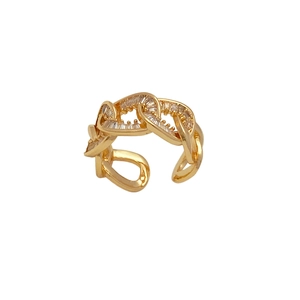 Macro view of gold plated hollow chain ring featuring rectangular zircon stones and open band