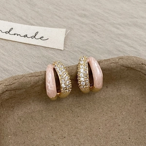 Detail of pink marble enamel C-shaped hoop earrings with sparkling zircon inlay