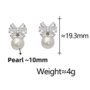 Sparkling bow-shaped stud earrings with zircons and 10mm white shell pearl pendants