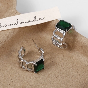 Detail view of vintage emerald green square zircon earrings with twisted silver chain links