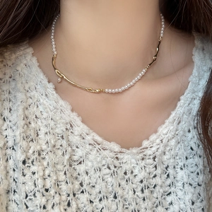 French vintage branch and pearl necklace styled on model with white knit sweater