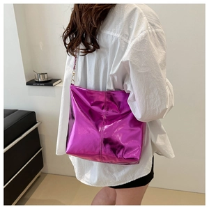Detail of metallic purple bucket bag with shiny mirror effect and golden chain strap