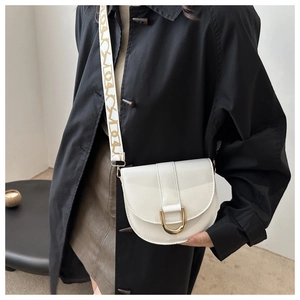 Detail of white semi-circular saddle bag in glossy patent leather with wide textile strap