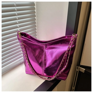 Detail of metallic purple tote bag with glossy finish and golden chain straps