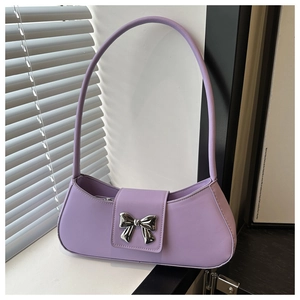Detail of lavender purple baguette bag featuring a silver butterfly buckle and fine texture