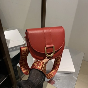 Stylish brick red saddle crossbody bag with patterned wide strap and gold hardware
