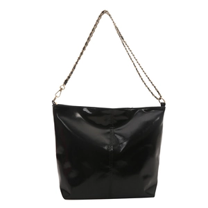Fashionable black glossy tote bag with gold chain strap and modern minimalist design