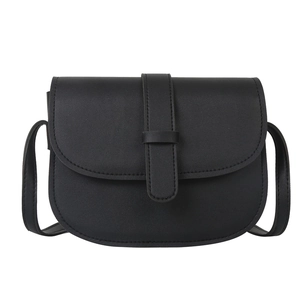 Minimalist black leather saddle bag with flap cover and thin crossbody shoulder strap