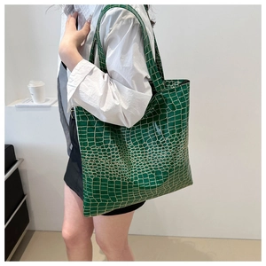 Green crocodile pattern tote bag shown over the shoulder for a trendy large capacity look