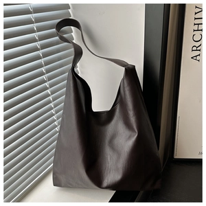 Close-up of deep brown tote bag with premium lychee texture and soft hobo style