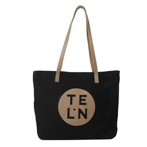 Minimalist black canvas tote bag with khaki leather handles and circular logo patch