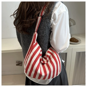 Detail of red and white striped canvas bag with thick woven texture and wide strap
