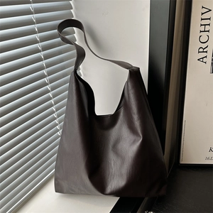 Minimalist large brown hobo tote bag in matte lychee grain leather for chic daily commute