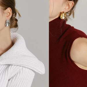 Irregular concave metal oval earrings in polished gold and silver finish for women