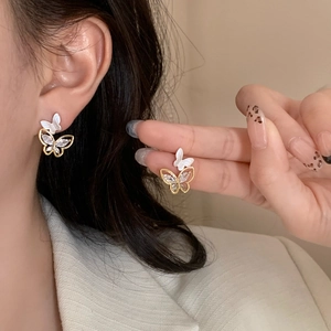 Detailed close-up of double-layered butterfly earrings with sparkling zircon crystals