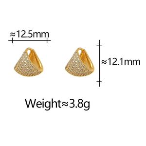 Macro shot showing dimensions of zircon studded gold bell earrings 12.5mm width