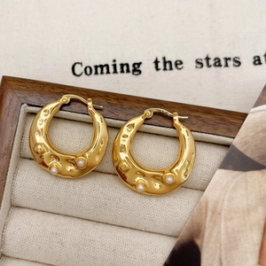 French vintage gold hoop earrings with hammer texture and white pearls in a jewelry box